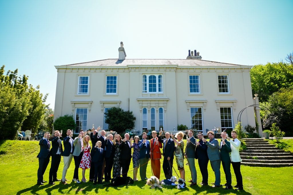 a group of people posing for a photo in front of a large building