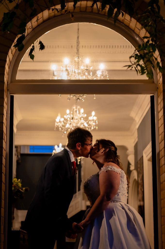 a man and woman kissing in a doorway