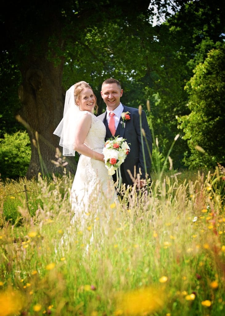 a man and woman in a field of flowers