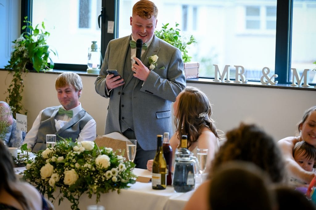 a man in a suit holding a microphone