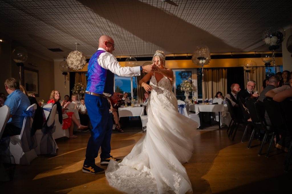 a man and woman dancing in a room