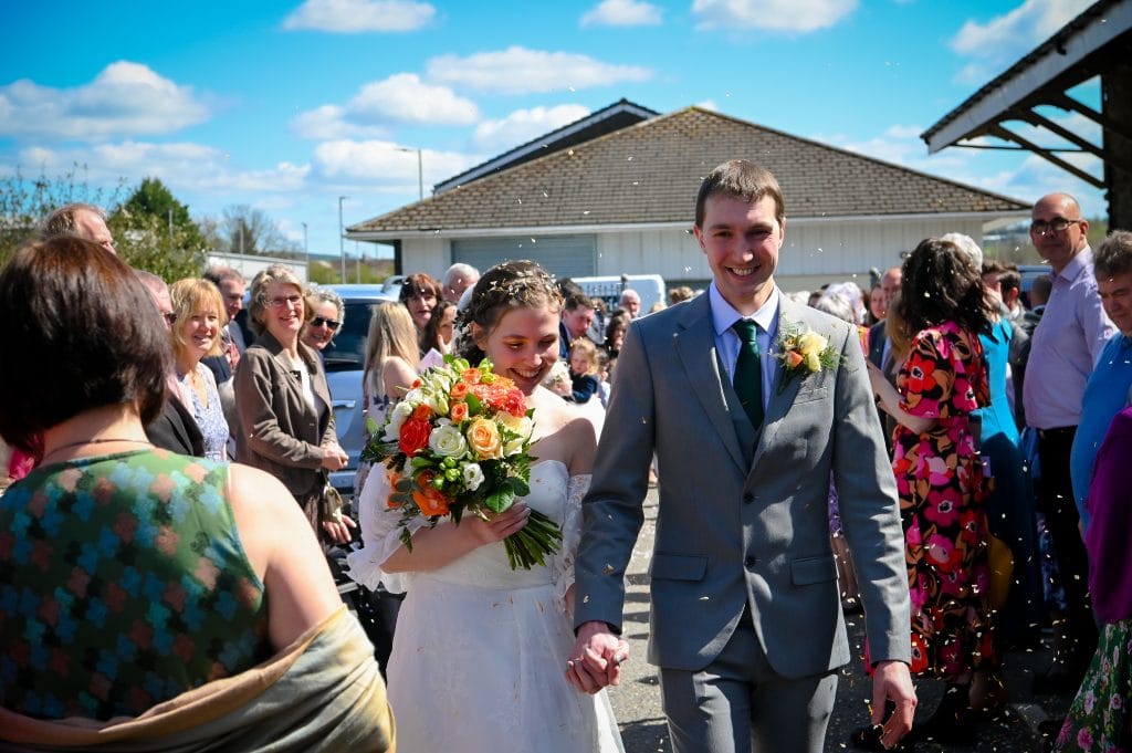 a man and woman walking down a street with a crowd of people