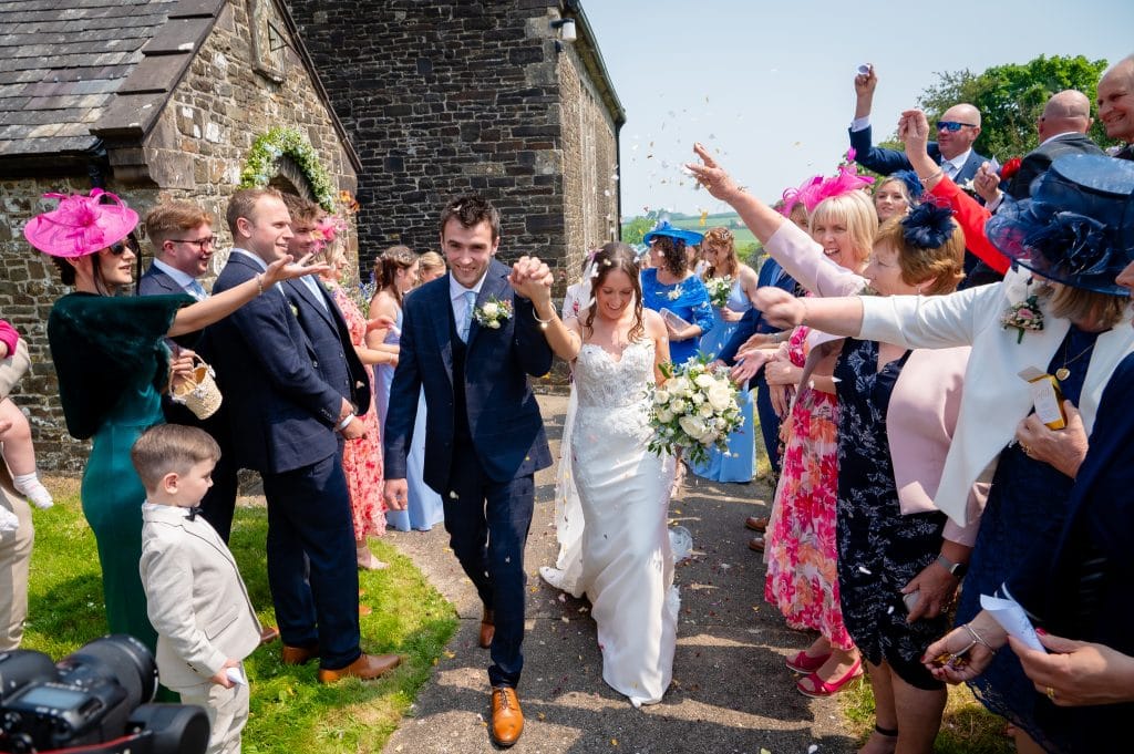 a man and woman walking down a path with confetti