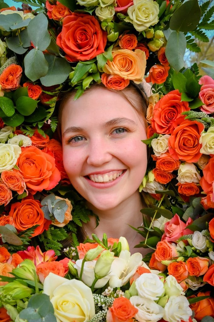 a woman smiling with flowers around her head