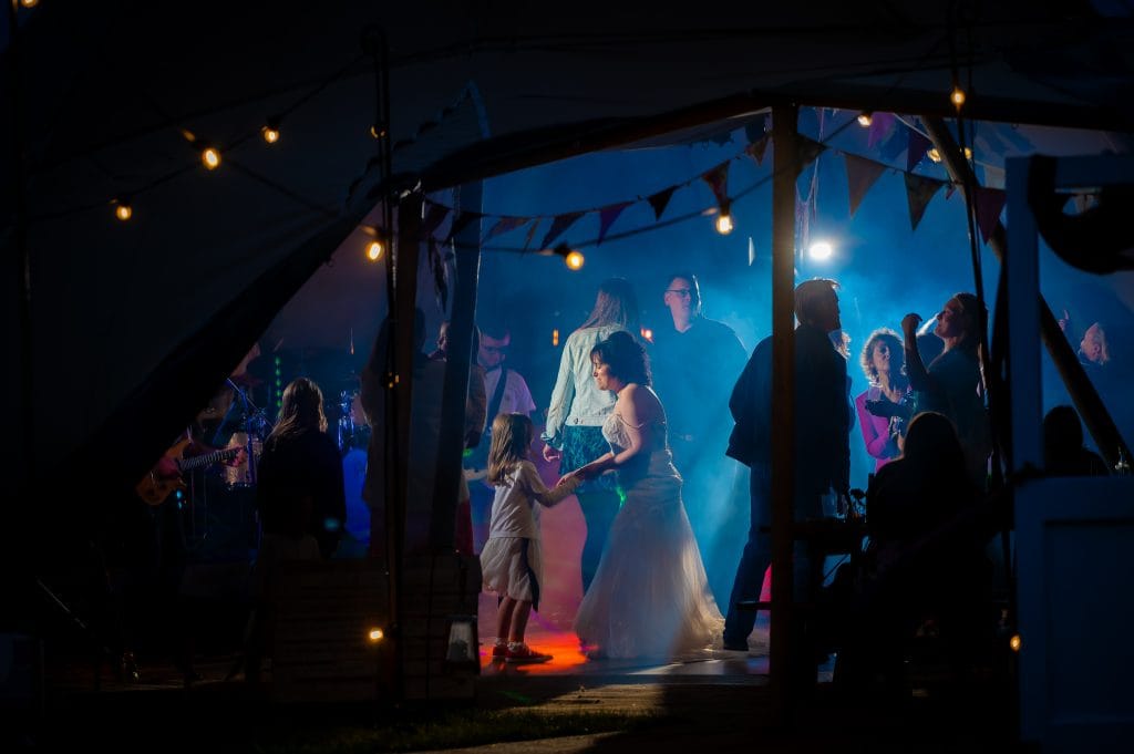a woman and child dancing in a tent