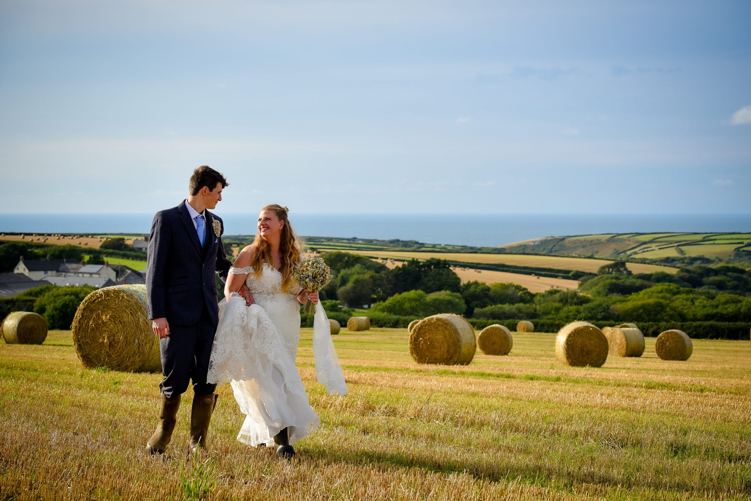 a man and woman in a field of hay