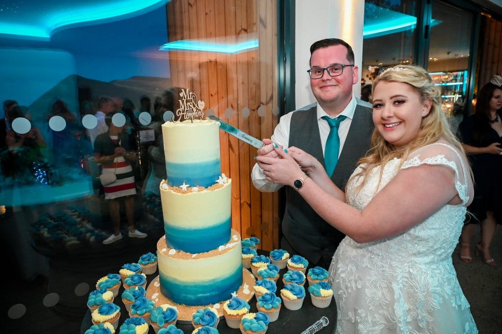 a man and woman cutting a cake