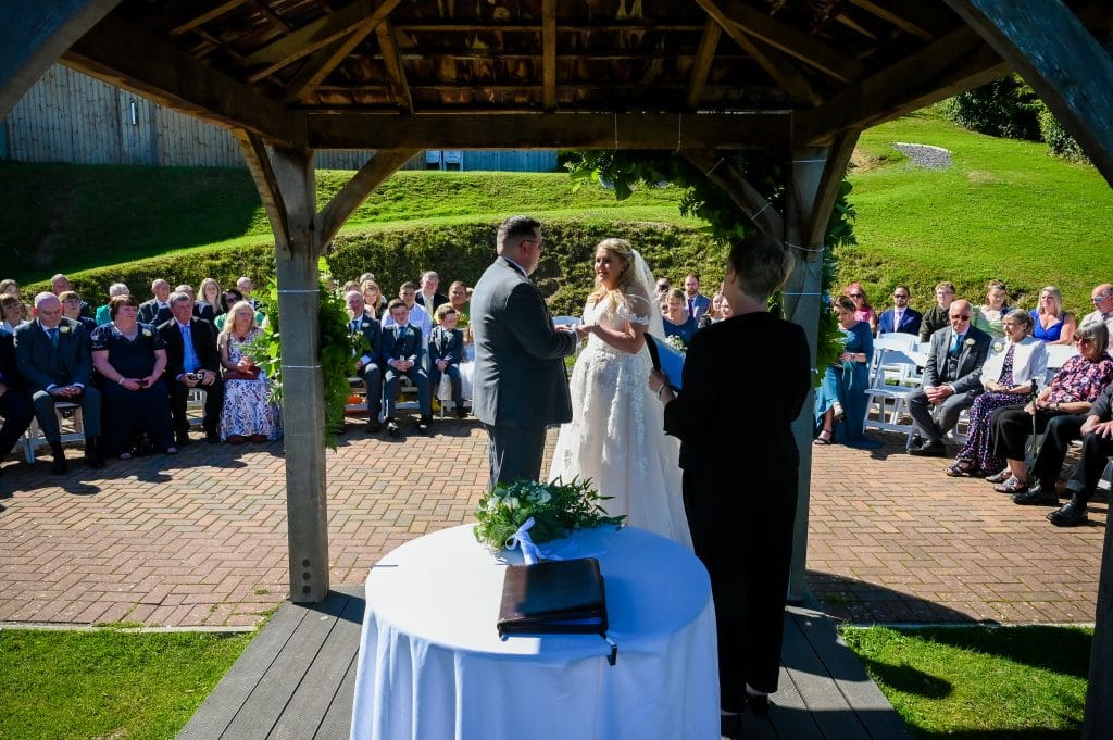 a man and woman standing under a gazebo
