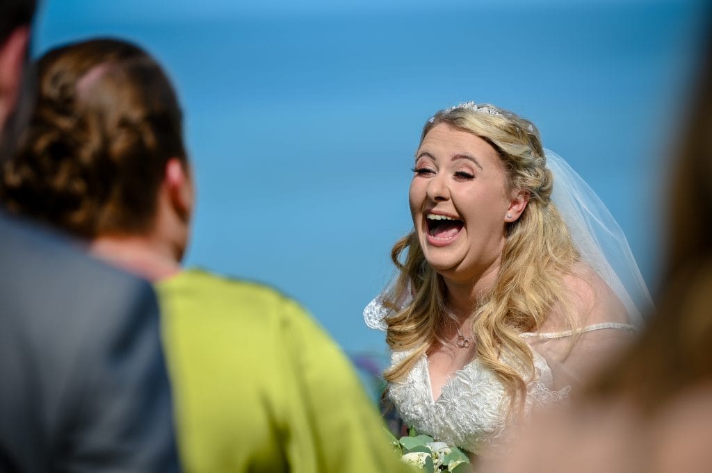 a woman in a wedding dress laughing